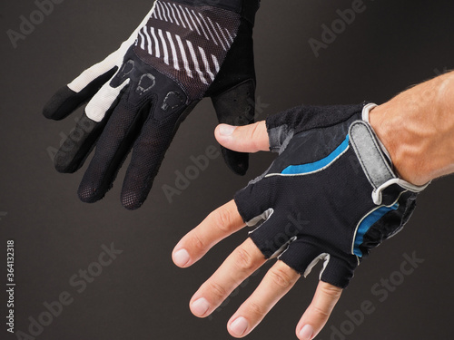 Close-up of men's hands in different Cycling gloves. photo