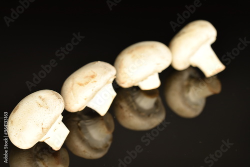Fresh mushrooms, close-up, on a black background.
