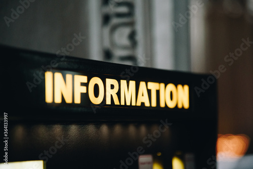Close up information sign with back light of white and yellow colour