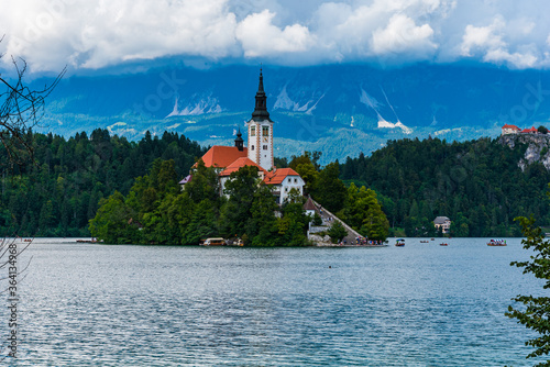 Beautiful cathedral in the middle of the lake surrounded by colourful trees © Vladyslav