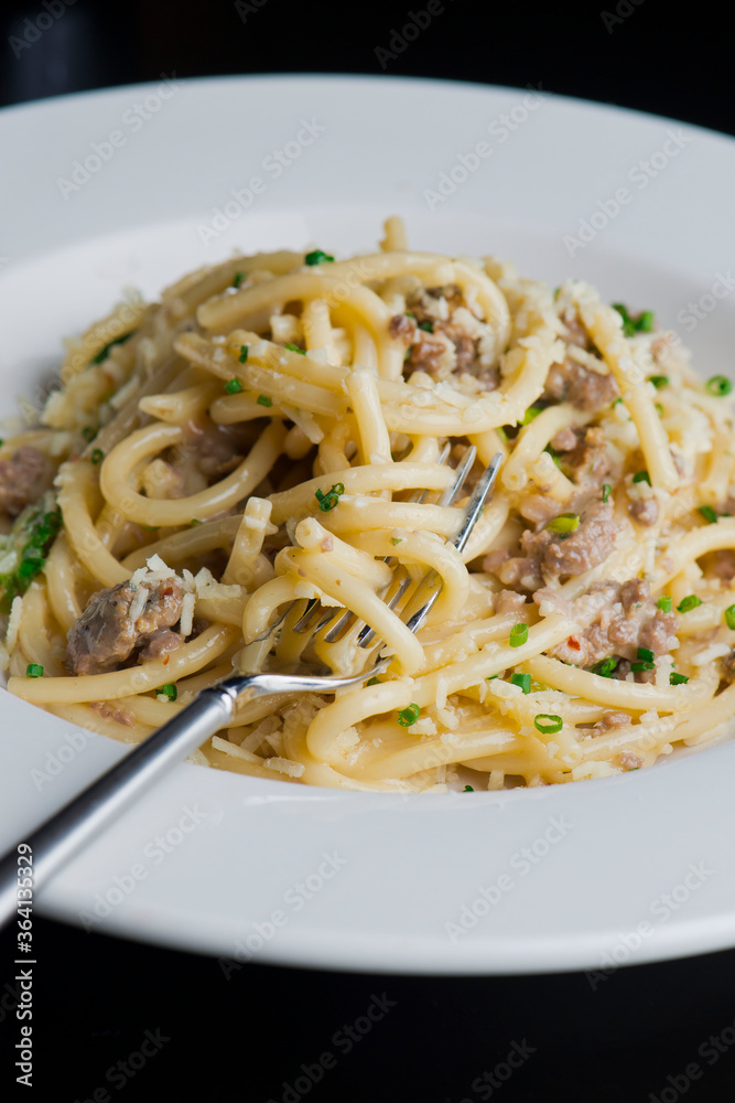 Pasta with meatballs, marinara sauce, Parmesan cheese and fresh Italian parsley. Classic American or Italian restaurant favorite. Homemade pasta with sauces, meats and cheeses.