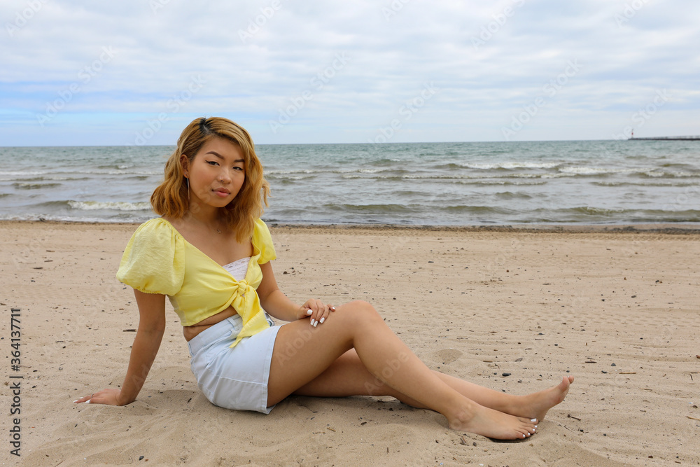 Beautiful young woman relaxing on the beach in the morning. Beautiful young woman relaxing on the beach in the morning.