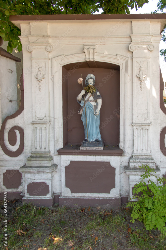 Figurine of St. James placed on the pilgrimage route to Santiago de Compostela (Camino) near the church of St. Jakub in Saczow in Poland.