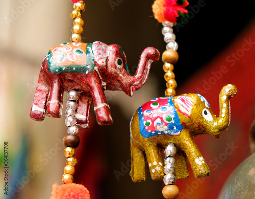 Decorative paper elephant figures, red and golden - symbols and signs of indian (hindu) and buddhist religions and tradition, low angle view. photo