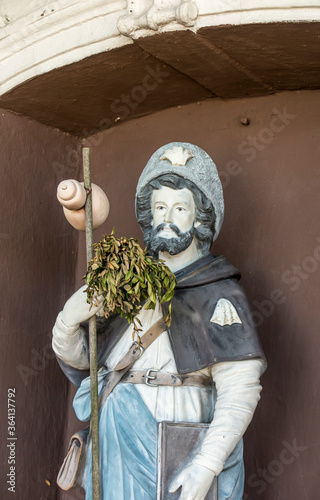 Figurine of St. James placed on the pilgrimage route to Santiago de Compostela (Camino) near the church of St. Jakub in Saczow in Poland. photo