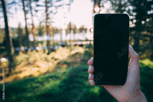 Holding a smartphone with summer background