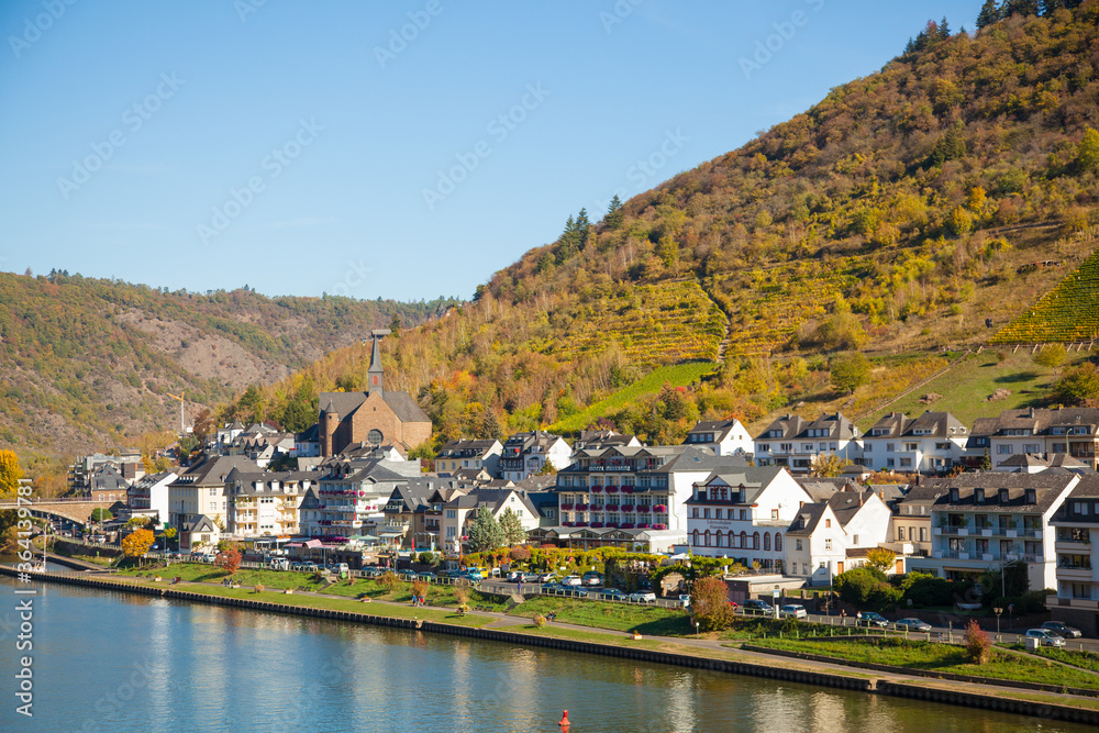 Autumn city of Cochem in Germany. October 2018. Many houses on the mountain among the vineyards and the Moselle river.