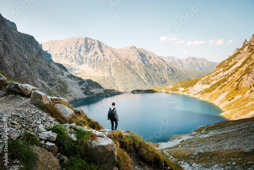 Obraz na płótnie Back view of male tourist hiking in Tatra mountains w salonie