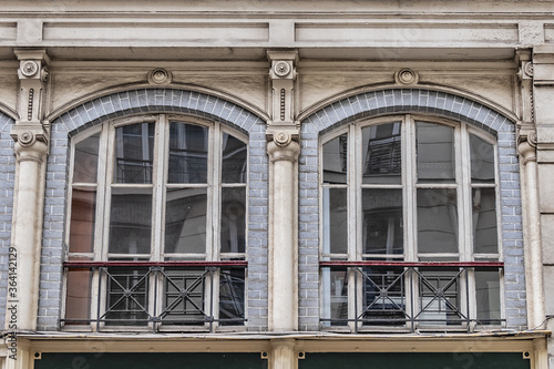 Old French house with traditional balconies and windows. Paris, France.