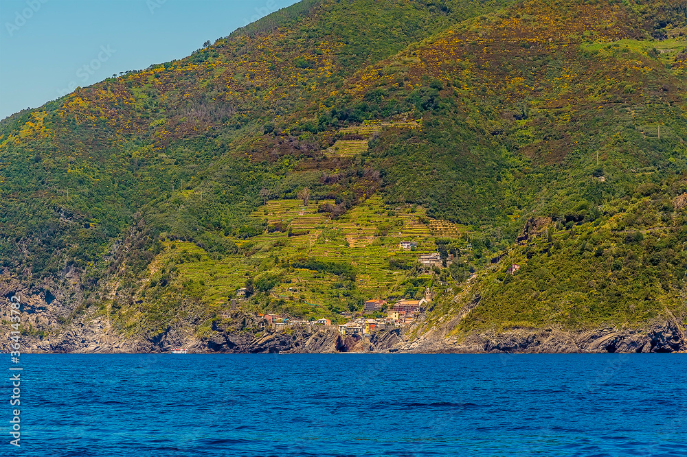 A view from the sea along the Cinque Terre coastline towards Vernazza in the summertime