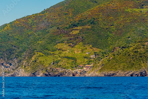 A view from the sea along the Cinque Terre coastline towards Vernazza in the summertime