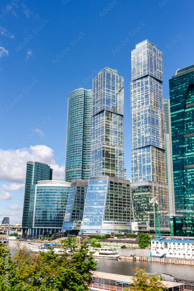 Cityscape of Moscow city with skyscrapers of Moscow International Business Center (MIBC). Blue sky with few clouds on a summer morning. Modern office buildings theme.