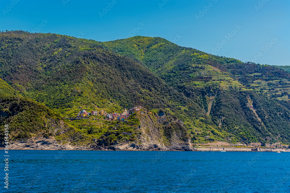 A view looking back towards the cliff top settlement of Corniglia and railway station in the summertime