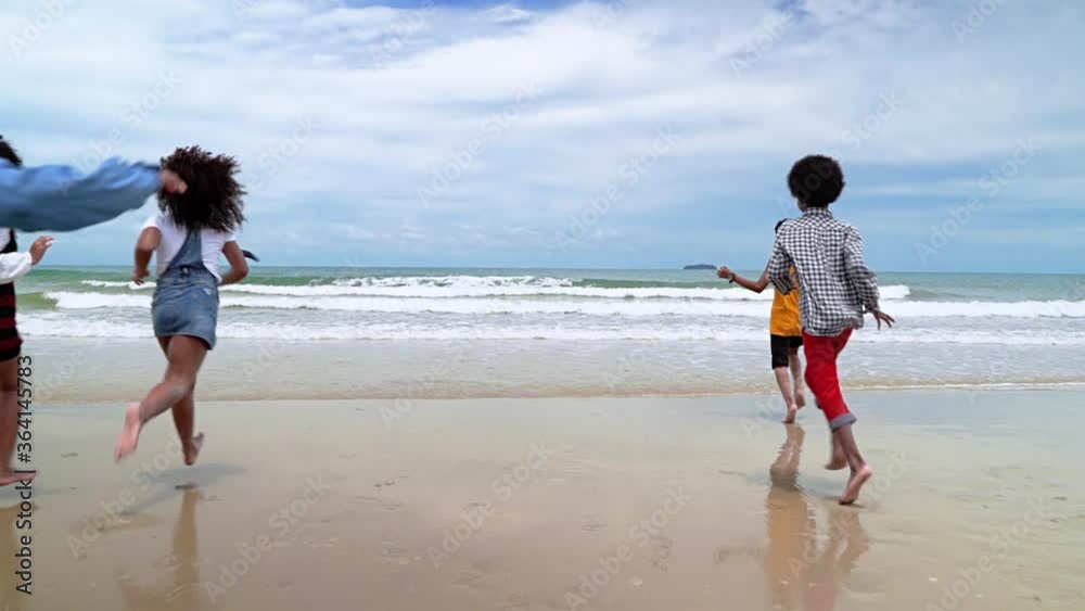 slow motion, african-American children are holding hands running on the beach in the summer
slow motion, african-American children are holding hands running on the beach in the summer