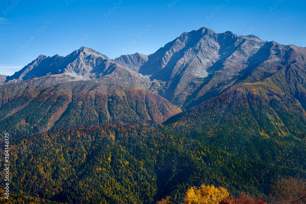 Beautiful view of the Caucasian mountain range. Chugush mountain and forest in autumn
