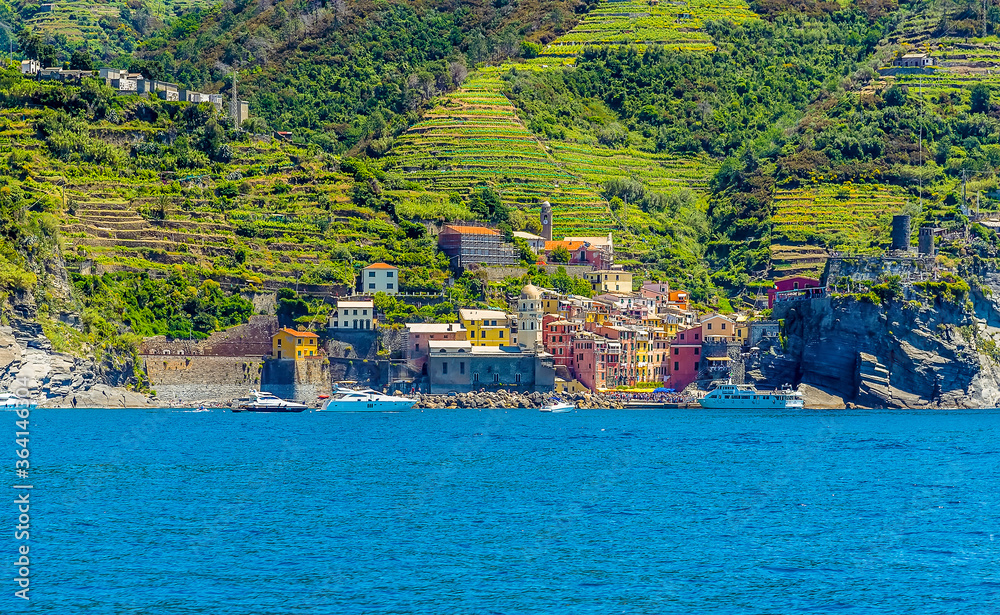 A view from the sea looking back towards the Cinque Terre village of Vernazza in the summertime
