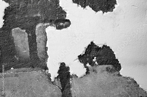 A ragged brick wall. Peeling putty, cement, paint. Unloaded wall, preparation for repair. Texture, cracked, chipped.