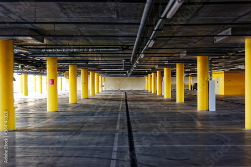 Parking garage  underground interior with a few parked cars