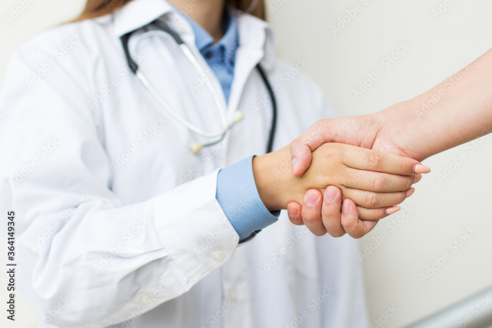 Doctor shakes hands with a patient isolated on white background Doctor shakes hands with a patient isolated on white background