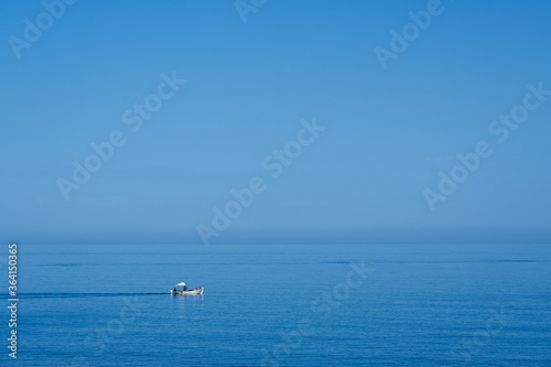 Fishing boat is going to the sea as a background. Copy space.