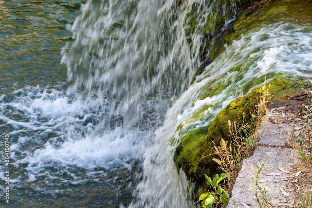 Small waterfall with crystal clear water in a stream in Granada Small waterfall with crystal clear water in a stream in Granada
