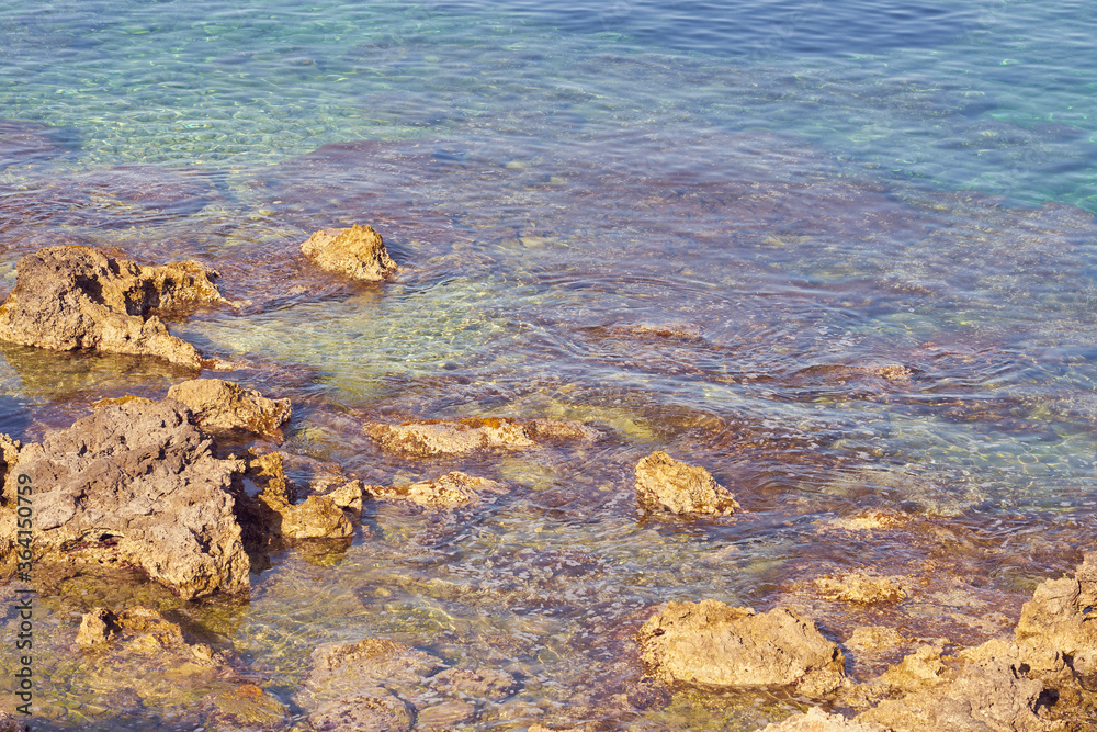 Rocky sea coast of Kolimvari in Crete Greece with turquoise water as a natural background. Copy space.