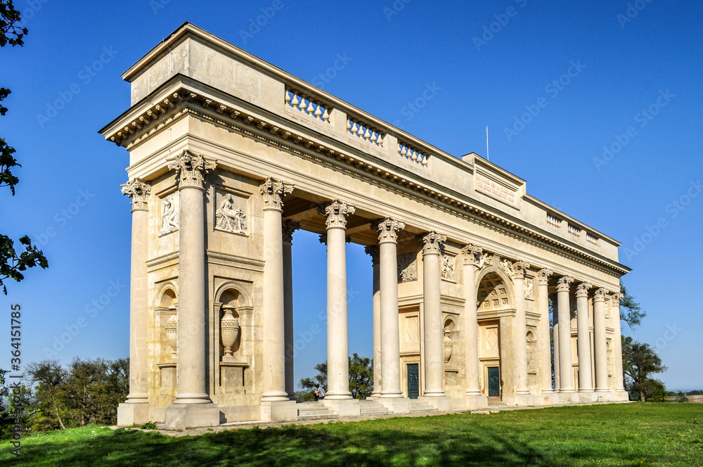 Rajsna Colonnade stands in a meadow by a small grove (Valtice, Czech Republic)
