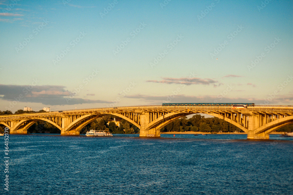 Fototapeta premium bridge over the river at the sunset