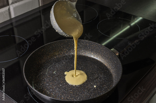 Cook fries pancakes in a pan on an induction cooker	

