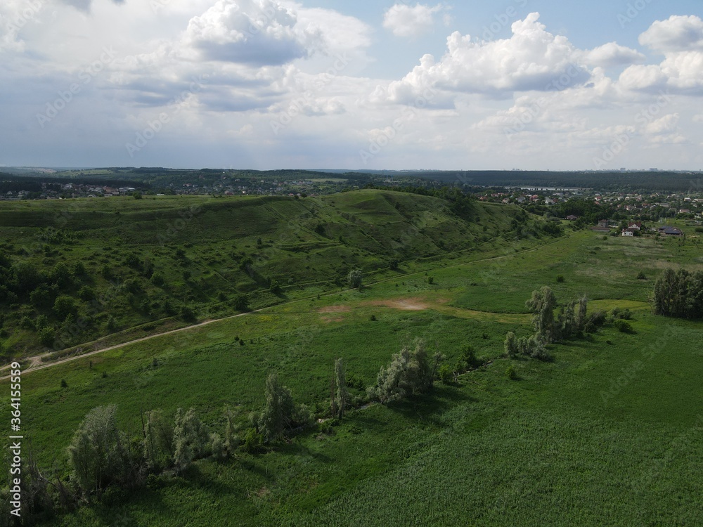 Aerial view of green hill on a cloudy day