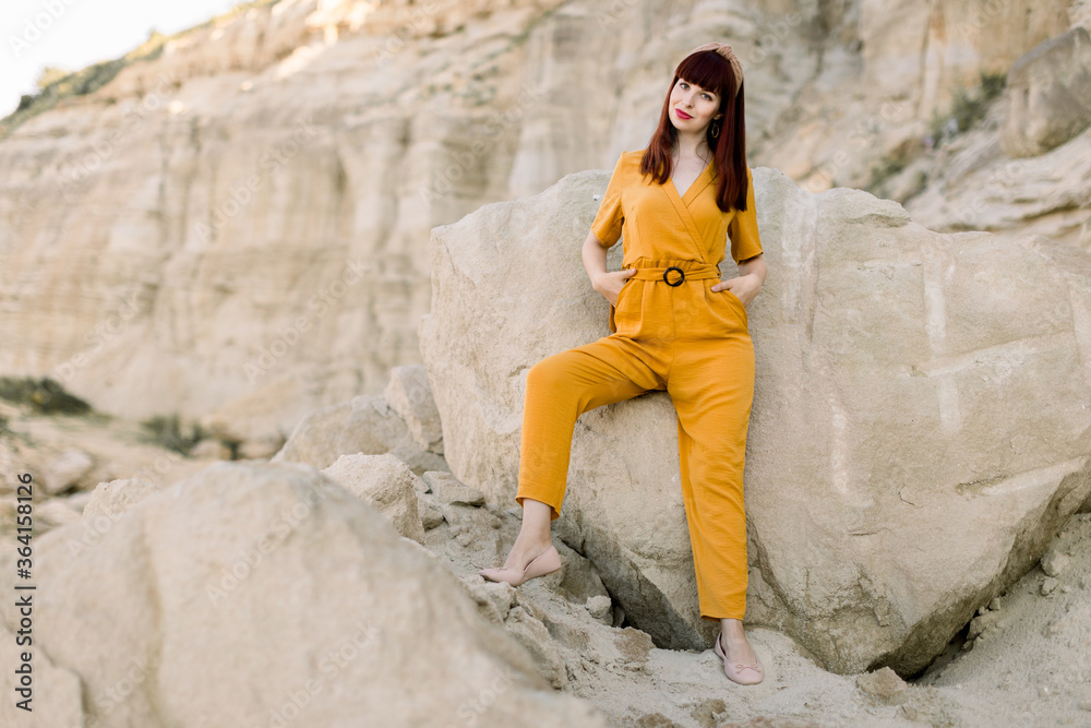 Attractive young woman with slim fit figure. Two girlfriends models in a quarry, by the sea, lake beach. Fashion boho style. Stylish fashion makeup. Free space. Attractive young woman with slim fit figure. Two girlfriends models in a quarry, by the sea, lake beach. Fashion boho style. Stylish fashion makeup. Free space.