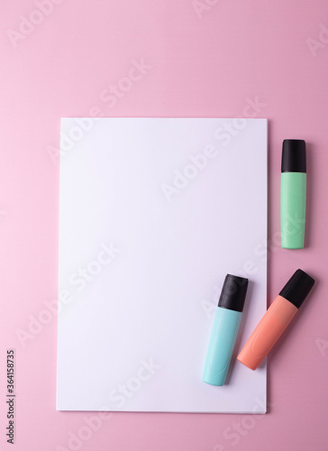 colorful stationary items on pink surface