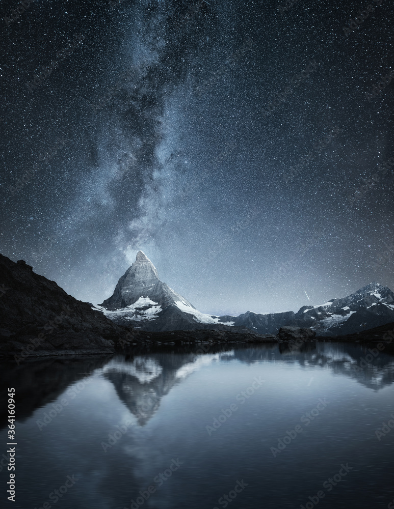 Matterhorn and reflection on the water surface at the night time. Milky way above Matterhorn, Switzerland. Travel - image