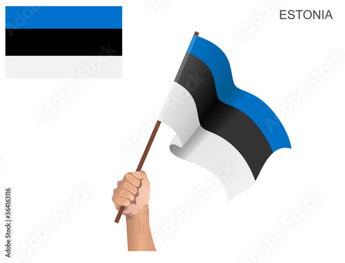 Estonian flag of the country hoisted with a stick held by hand to ignite the spirit of statehood
