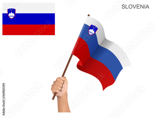 Flag of the country of Slovenia hoisted with a stick held by hand to ignite the spirit of statehood