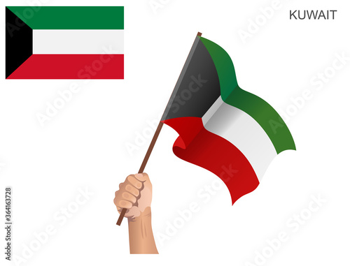 Flag of the State of Kuwait hoisted with a stick held by hand to inflame the spirit of statehood