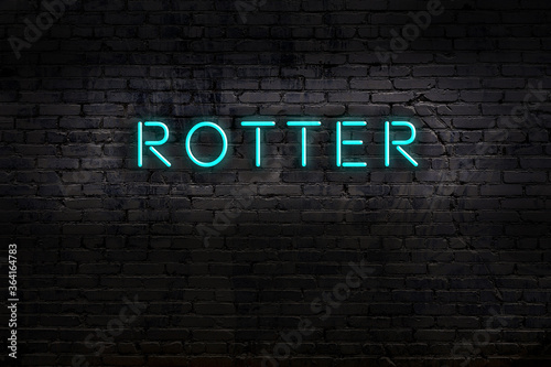 Neon sign. Word rotter against brick wall. Night view photo