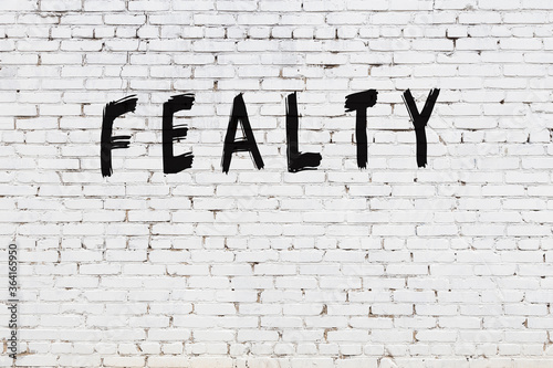 Inscription fealty painted on white brick wall