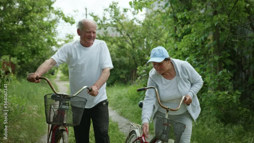 happy retirement couple leads an active lifestyle enjoy a bike ride talking and smile on warm sunny day out of town happy retirement couple leads an active lifestyle enjoy a bike ride talking and smile on warm sunny day out of town