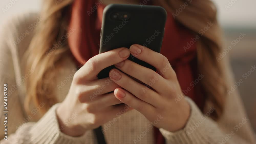 Woman hands writing message by phone outdoors. Unknown girl typing smartphone