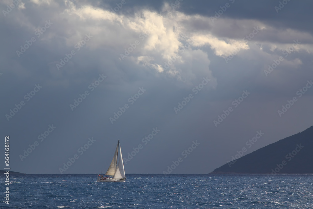 Sailing ship yachts with white sails in race the regatta in the open sea	
