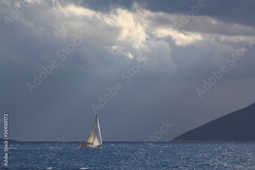 Sailing ship yachts with white sails in race the regatta in the open sea 