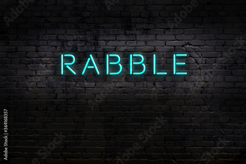 Foto Neon sign. Word rabble against brick wall. Night view