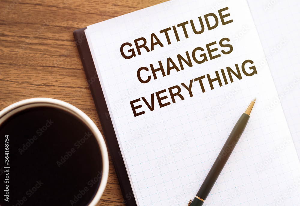 Gratitude changes everything - writing on notepad with a cup of espresso coffee Gratitude changes everything - writing on notepad with a cup of espresso coffee