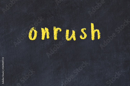 College chalk desk with the word onrush written on in