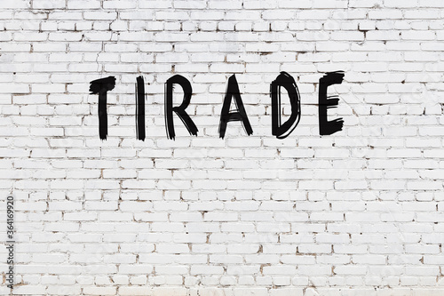 White wall with black paint inscription tirade on it