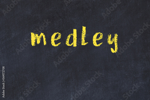 Fotografi College chalk desk with the word medley written on in