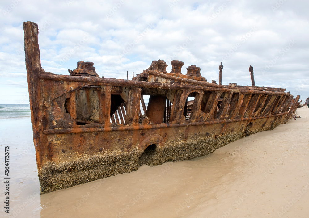 The rusting wreck of the ship  Maheno on the beach on  Fraser Island Queensland , Australia.