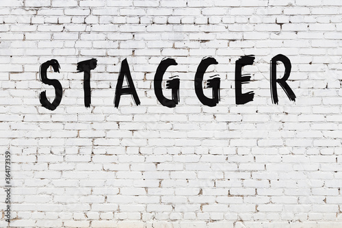 Fotografie Inscription stagger painted on white brick wall