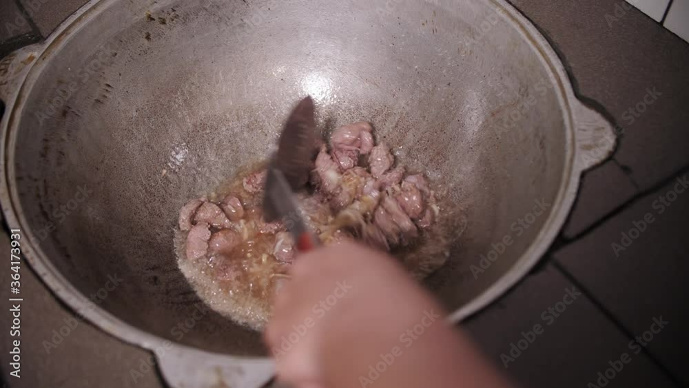 cooking pilaf in a cast iron cauldron cooking pilaf in a cast iron cauldron